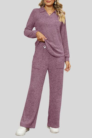 a woman wearing a purple sweater and pants