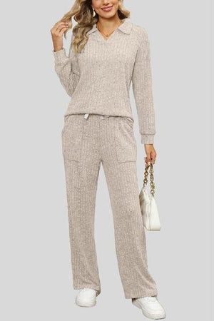 a woman in a gray sweater and pants