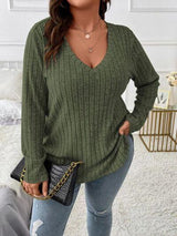 a woman wearing a green sweater and jeans