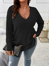 a woman wearing a black sweater and jeans