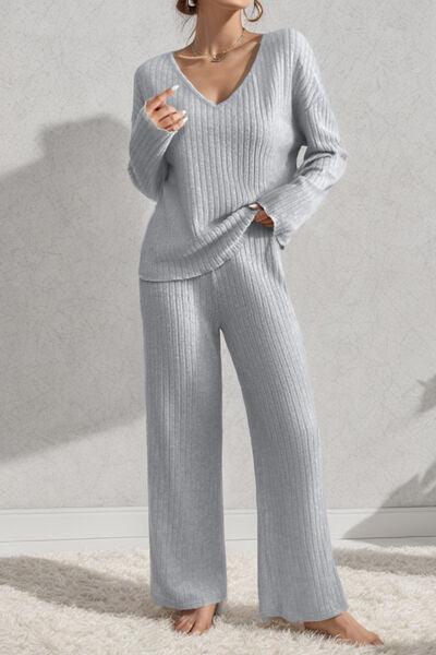 a woman in a grey sweater and pants