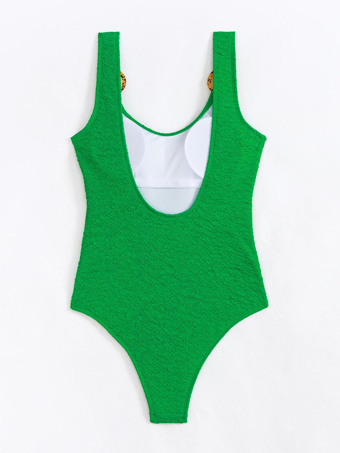 a green one piece swimsuit on a white background