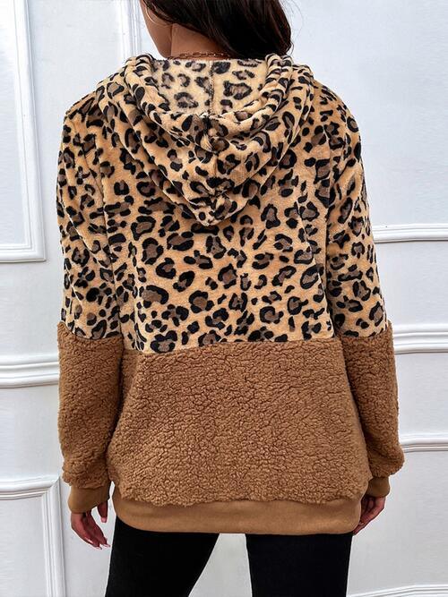 a woman wearing a leopard print hoodie