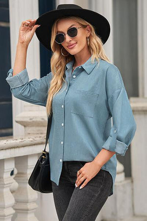 a woman wearing a blue shirt and black hat
