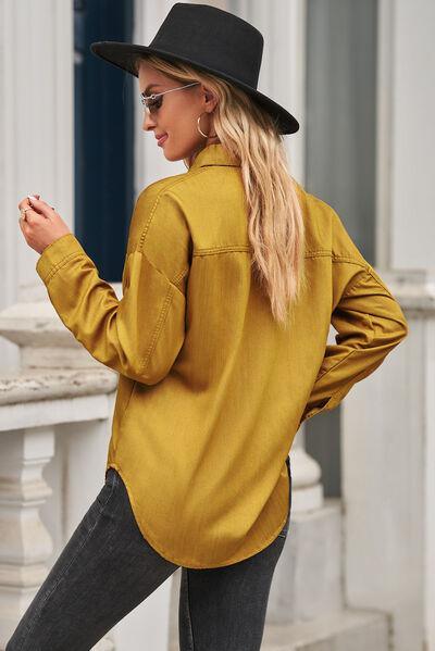 a woman in a black hat and a yellow shirt