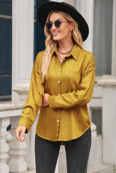 a woman wearing a yellow shirt and black hat