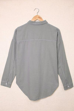 a gray shirt hanging on a hanger