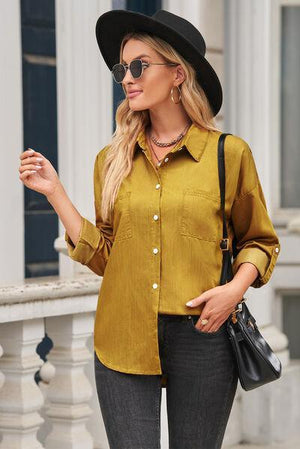 a woman in a yellow shirt and black hat