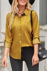 a woman wearing a black hat and a yellow shirt