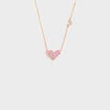 a heart shaped necklace with a diamond on it