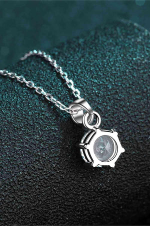 a silver necklace with a white diamond on it