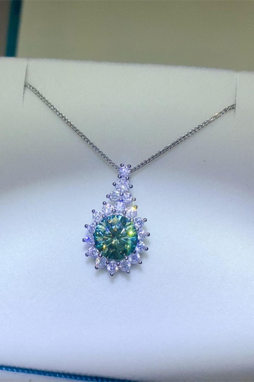 a necklace with a blue and green diamond in it