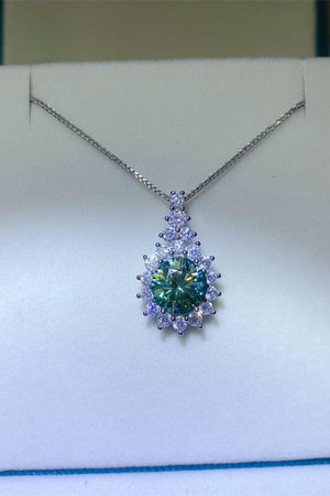 a necklace with a green and blue stone in the center
