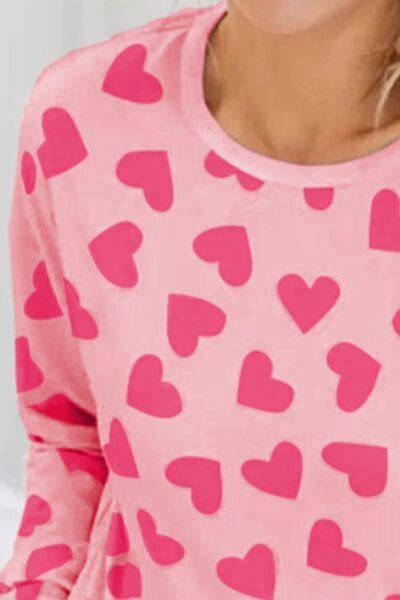 a woman wearing a pink shirt with hearts on it