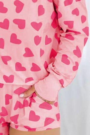 a woman in pink pajamas with hearts on it