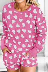 a woman wearing a pink and white heart pajamas