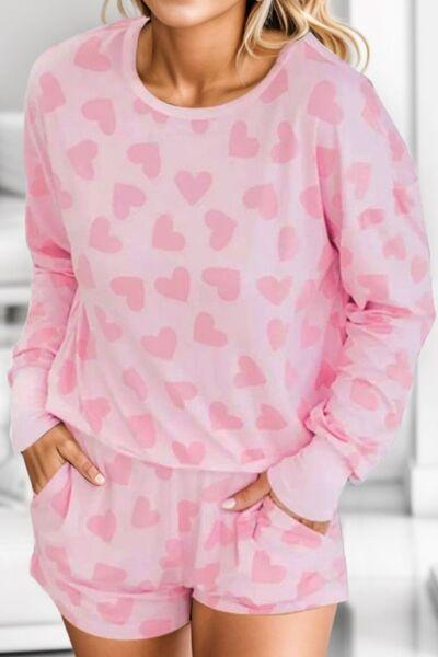 a woman wearing a pink heart print pajamas