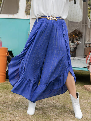 a woman wearing a blue skirt and white shirt