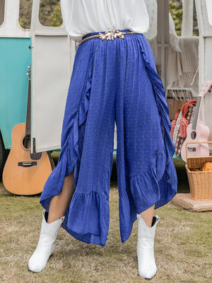 a woman wearing a white shirt and blue pants