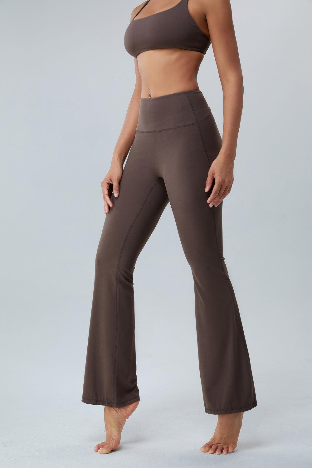 a woman in a bra top and wide legged pants