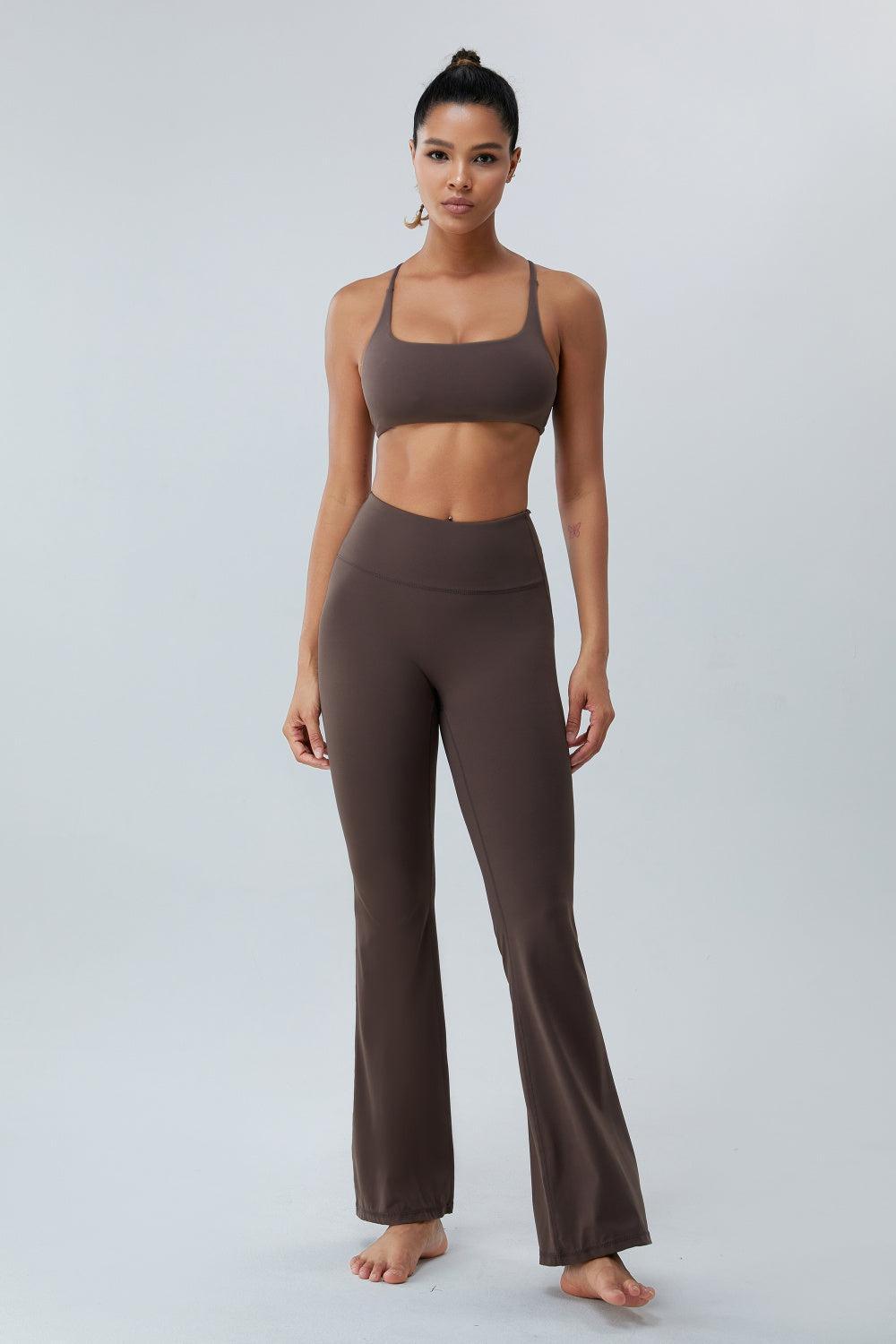 a woman in a brown sports bra top and wide legged pants