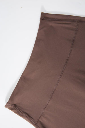 a close up of a brown skirt on a white surface