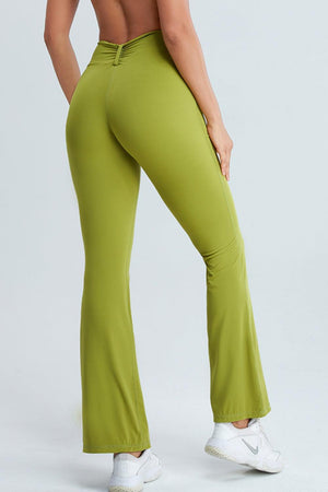a woman in green pants with her back to the camera