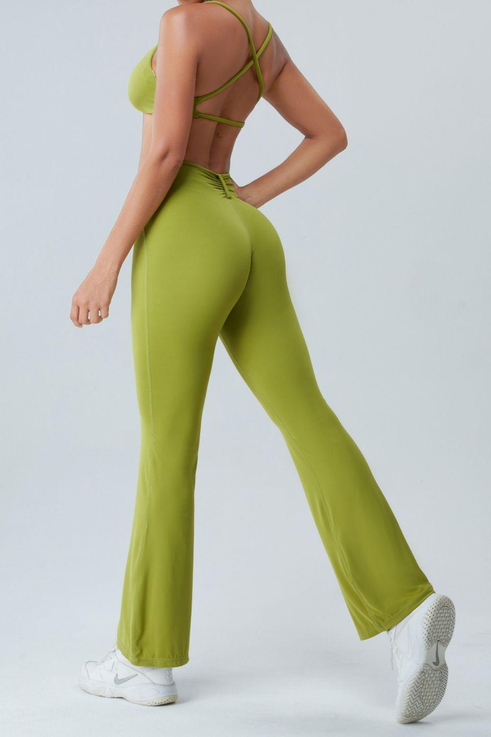 a woman in green pants and a bra top