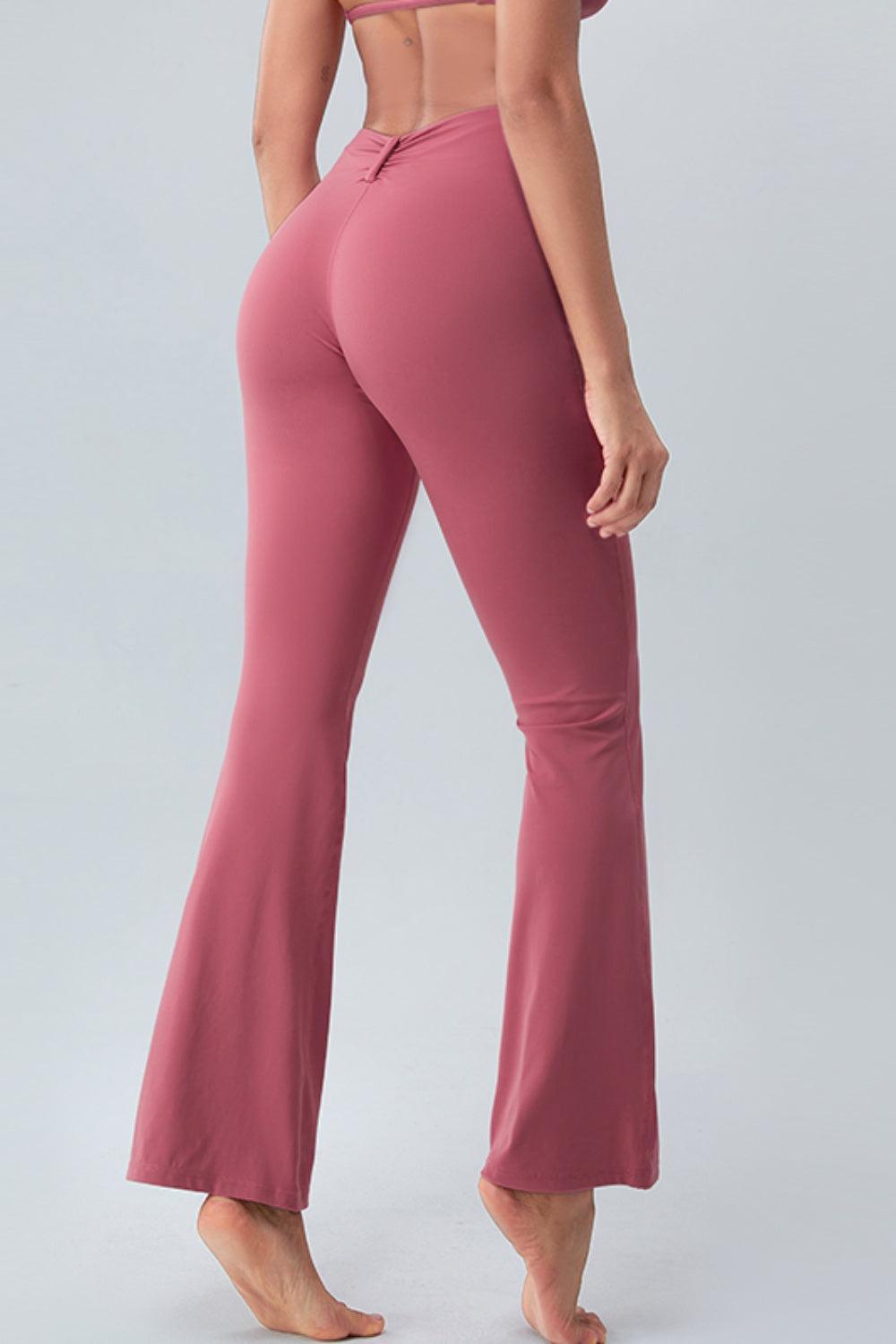 a woman in pink pants and a bra top