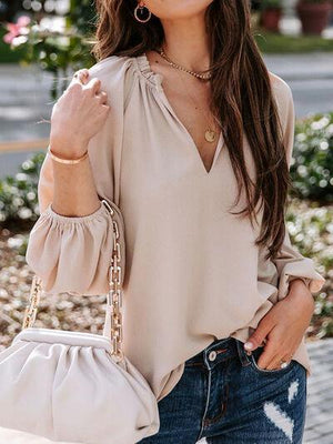 a woman holding a white purse and smiling