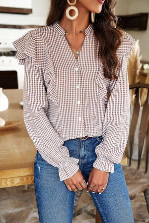 a woman wearing a brown and white checkered shirt