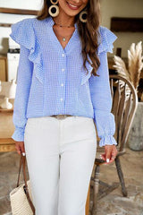 a woman wearing a blue and white shirt and white pants