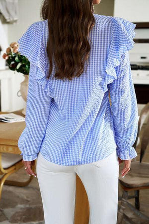 a woman wearing a blue and white checkered top