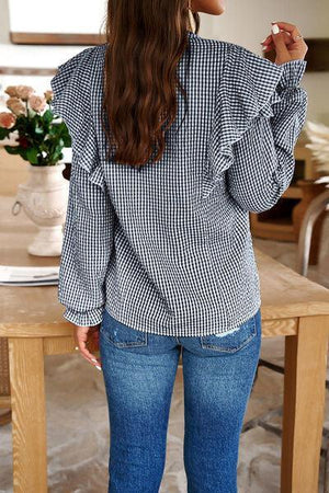 a woman standing in front of a wooden table