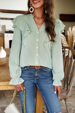 a woman wearing a green and white checkered shirt