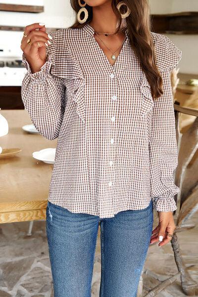 a woman wearing a brown and white checkered shirt