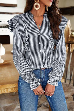 a woman wearing a black and white checkered shirt