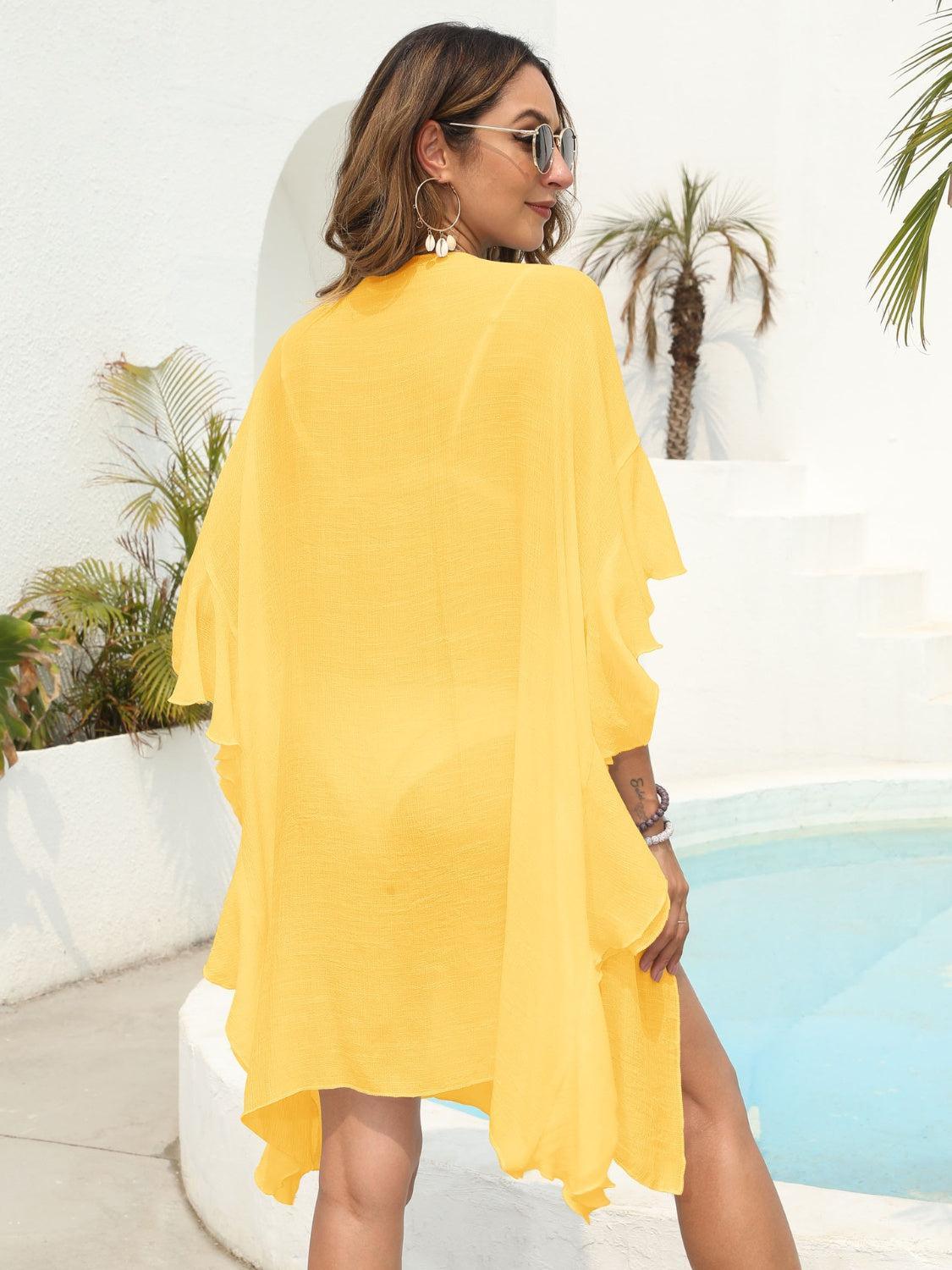 a woman in a yellow dress standing next to a pool