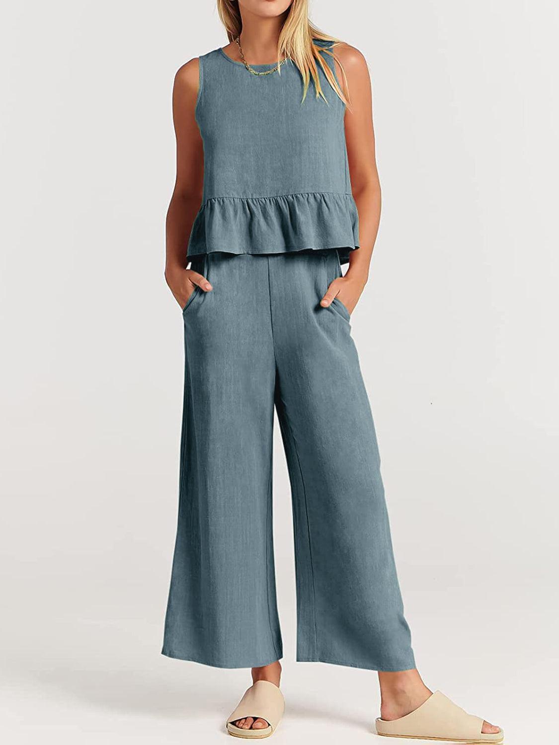 a woman wearing a blue top and wide legged pants