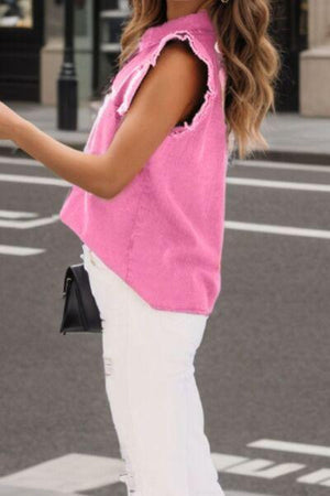 a woman in a pink top is crossing the street