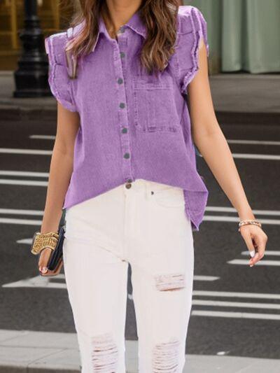 a woman in a purple shirt and white jeans