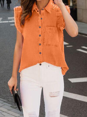 a woman in an orange shirt and white jeans