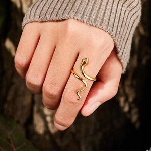 a woman's hand with a gold ring on it