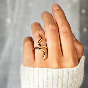 a woman's hand with a gold ring on it