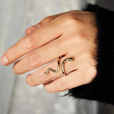 a woman's hand with a gold ring on it