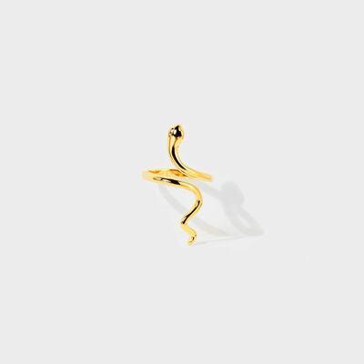 a gold snake ring on a white background