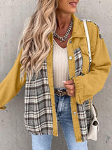 a woman wearing a yellow jacket and jeans