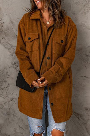 a woman wearing a brown coat and ripped jeans