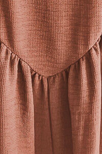 a close up of a person wearing a brown dress