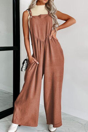 a woman wearing a brown jumpsuit